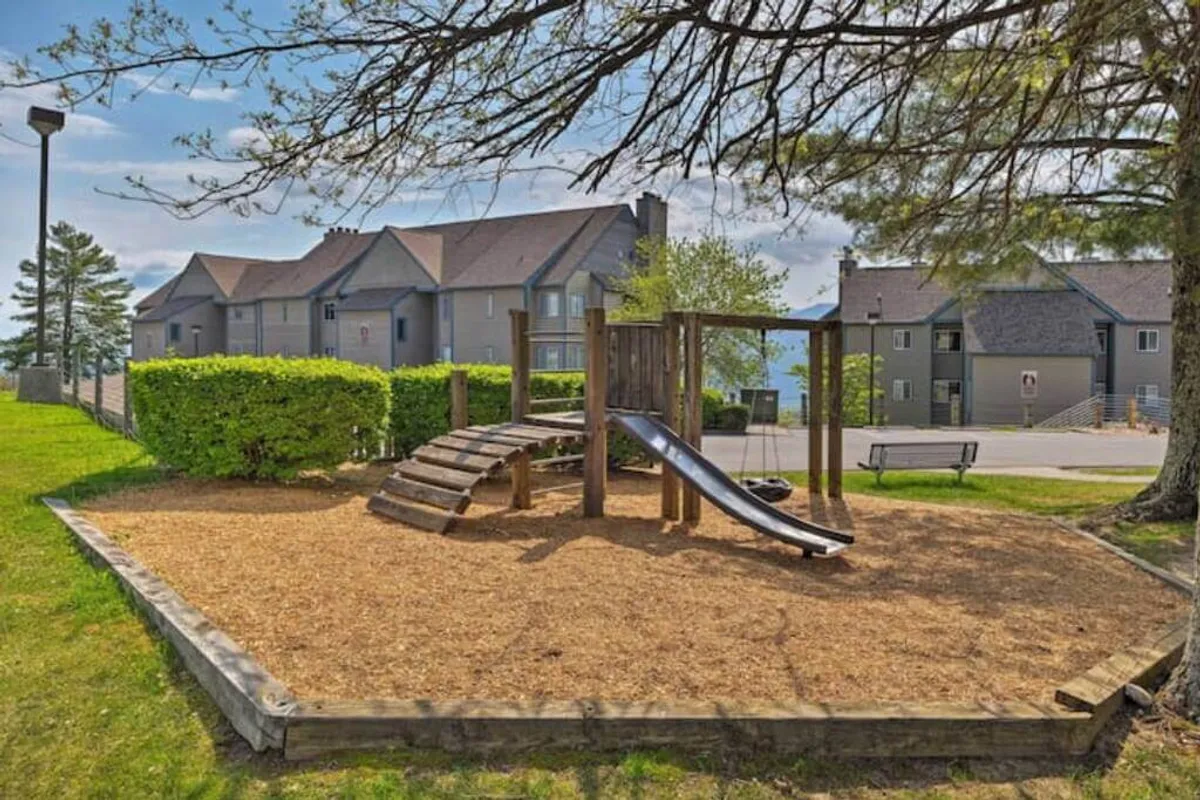 A cheerful playground set amidst lush greenery, featuring slides and other equipment. The environment is bright and inviting, ideal for children and family gatherings.